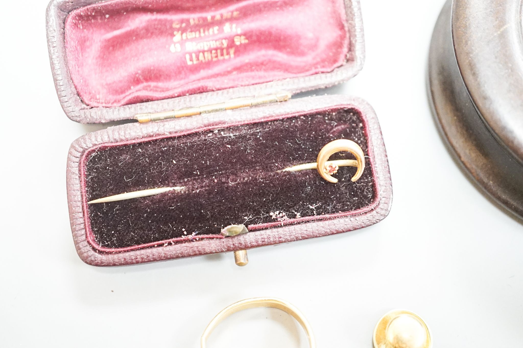A yellow metal signet ring(a.f.) 7.1 grams, four assorted yellow metal dress studs stamped 18, 7 grams, one other stud stamped 15, 1.2 grams, a 9ct and gem set stick pin, gross 0.6 grams and six cased yellow metal studs.